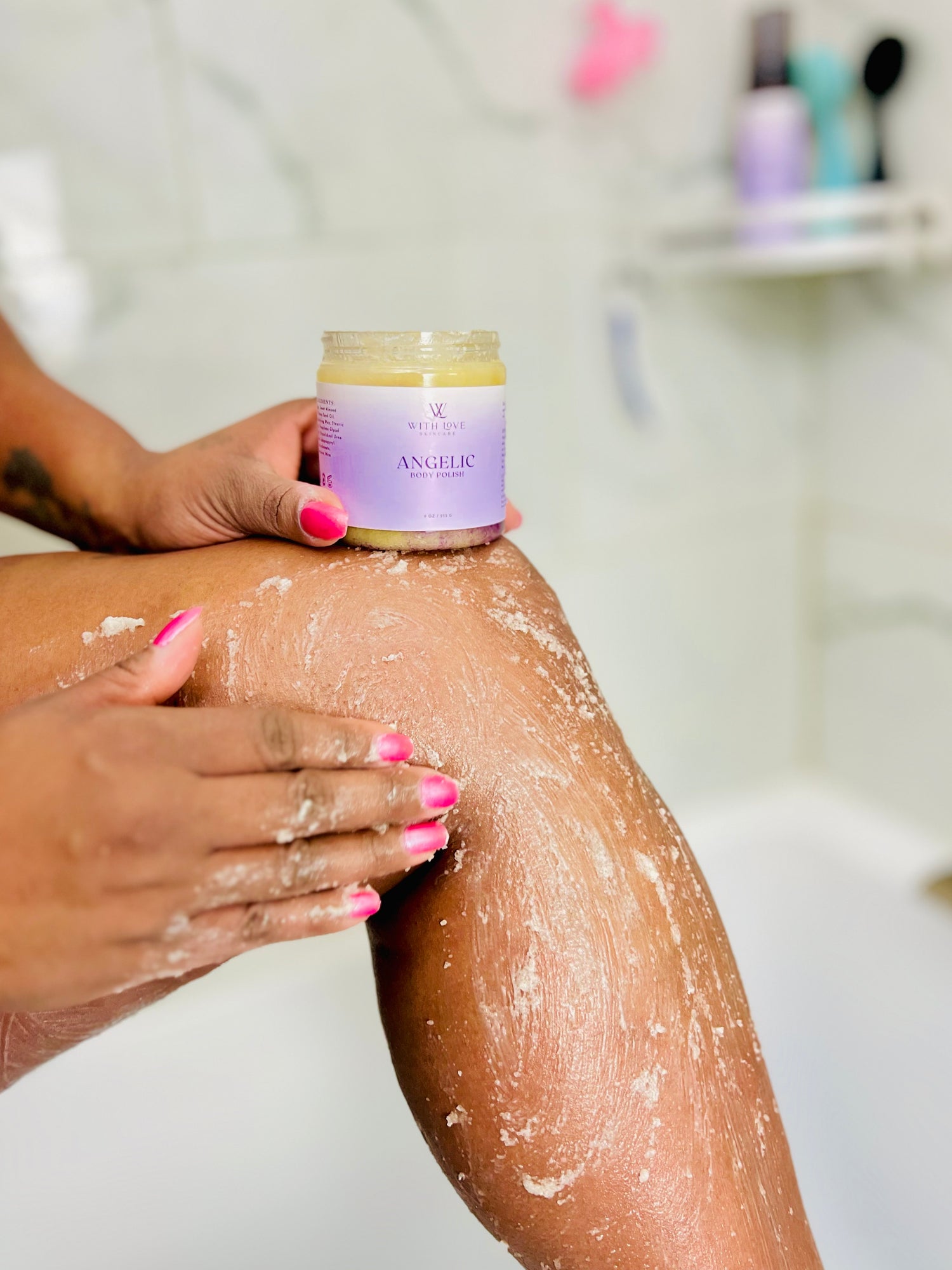Woman applying With Love Body's Essential Skin Care Angelic Body Polish to exfoliate dead skin.