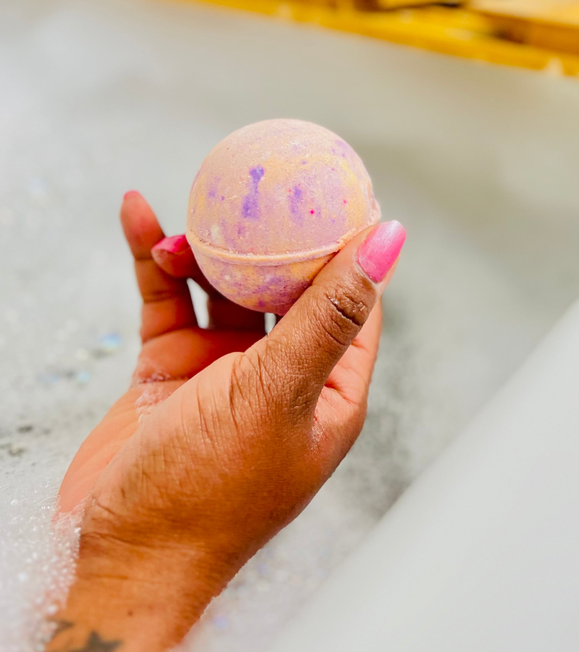 Women holding bath bomb in hand