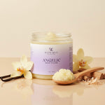 Jar of 'Angelic' body polish with vanilla beans and flowers on a beige background