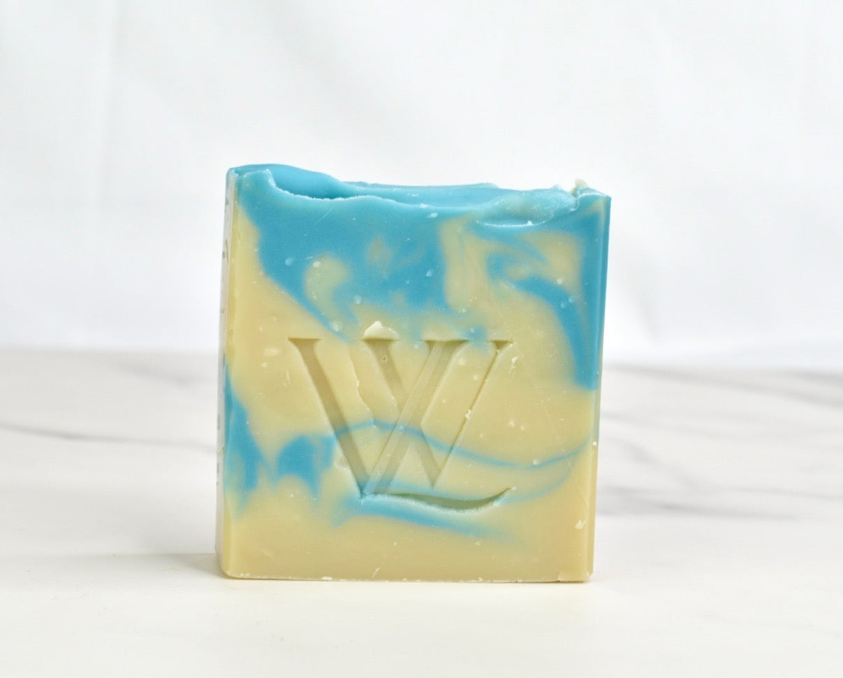 Bar of soap with a blue and white swirl pattern on a white background