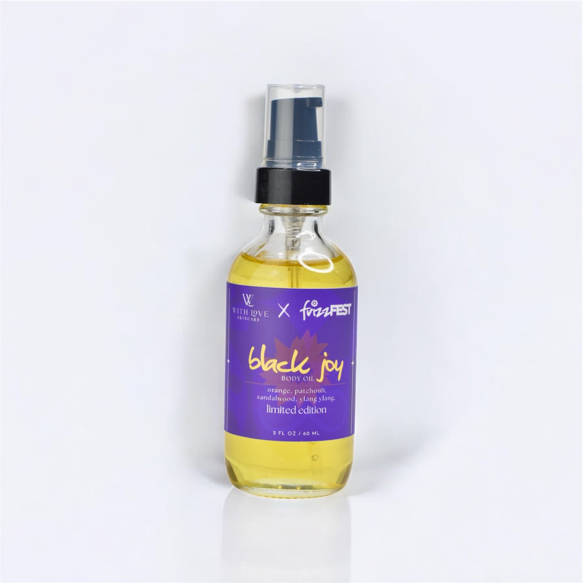 Bottle of 'black joy' body oil with a purple label on a white background